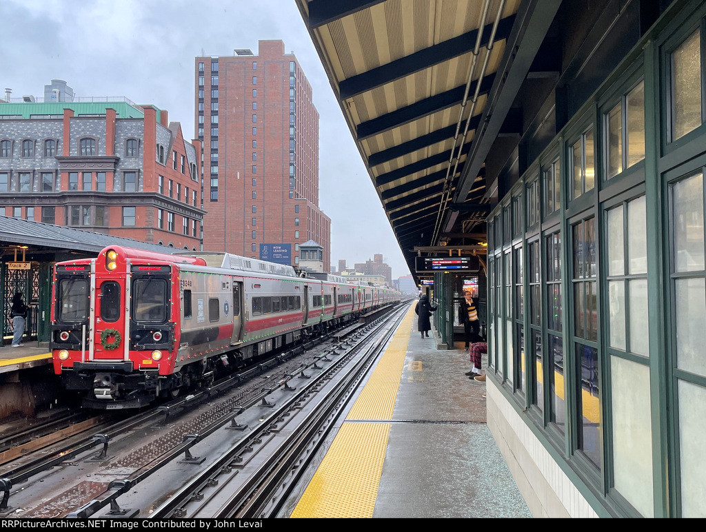 Metro North Train, with the Holiday Lights M8 Set, arrives into Harlem 125th Street Station, enroute from Southeast to Grand Central Terminal 